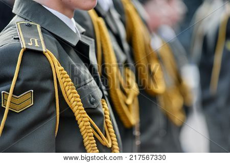 Closeup of military officers on parade wearing uniform with epaulettes
