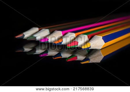 Coloured Pencils On A Reflective Glass Mirror Surface