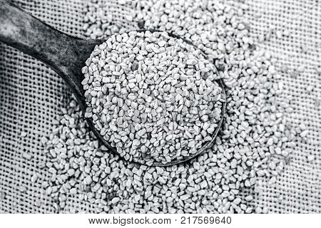 Fenugreek Seeds In A Wooden Scoop On A Gunny Background.