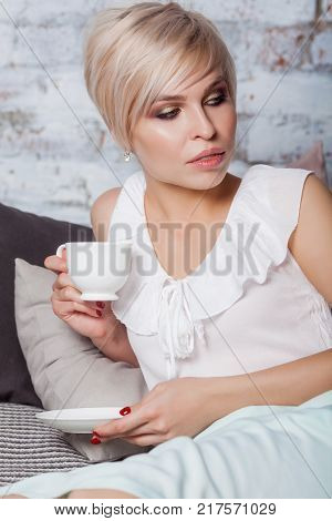 Beautiful Woman Sitting On Leather Sofa