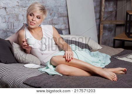 Beautiful Woman Sitting On Leather Sofa