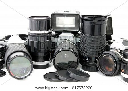 Set of old camera with lenses and a flash camera isolated on white background