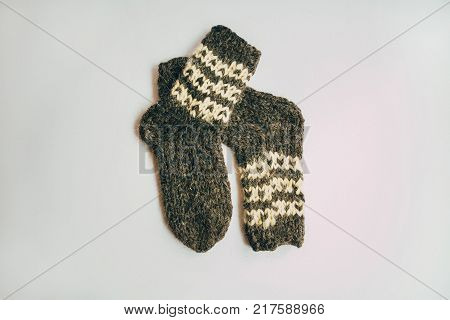 Stack Of Handmade Warm Knitted Socks Scarfs Mittens From Rough Wool Yarn Brown Beige Grey On Wood Ta