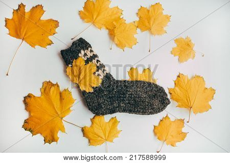 Stack Of Handmade Warm Knitted Socks Scarfs Mittens From Rough Wool Yarn Brown Beige Grey On Wood Ta