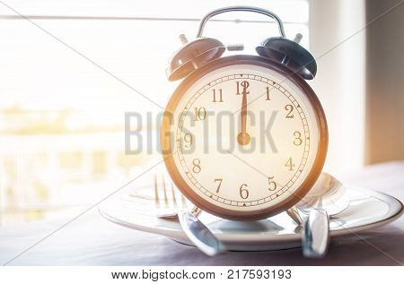 Retro stopwatch to put on plate. Weight loss for good Healthy. Diet is sum of food consumed by person or other organism. Lunch Time to diet concept.