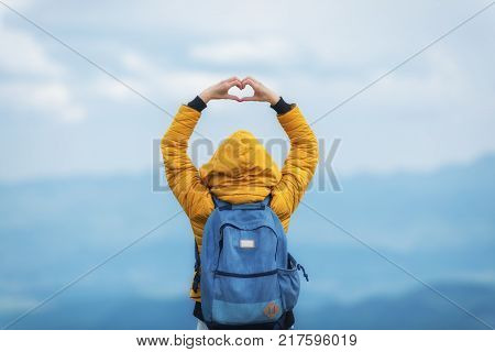 Girl holding a heart - shape in the nature.