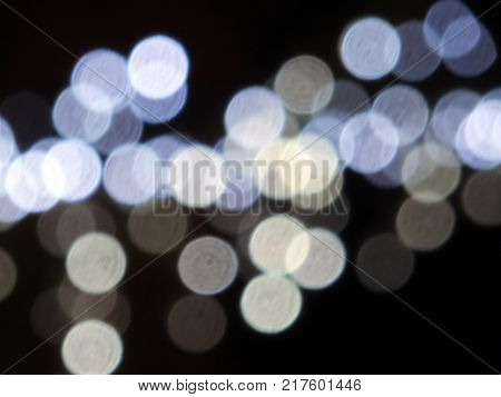 round white bright and blue blurred restive lights against a dark night background