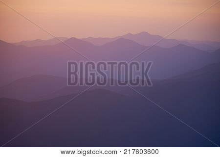 Natural background with ultraviolet mountains after sunset