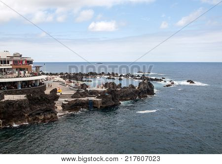 PORTO MONIZ MADEIRA PORTUGAL - SEPTEMBER 5 2016: Natural rock pool of Porto Moniz. It is a public bath with water from the Atlantic Ocean.