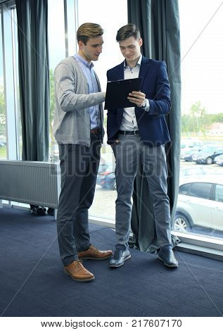 Two businessman dicussing business in the office