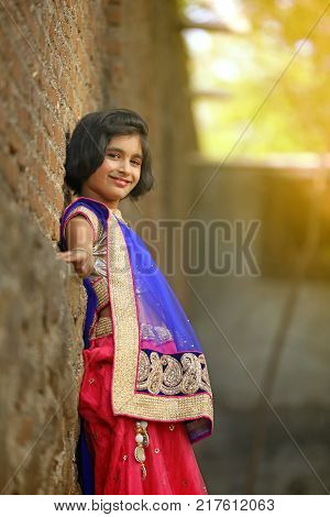 young happy indian child posing on saree