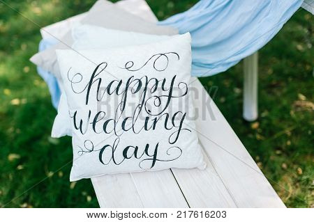 wedding, decor, gardening concept. original idea of garden decoration for nuptial in form of tidy little cushions in white and grey colours with interesting print of greeting words