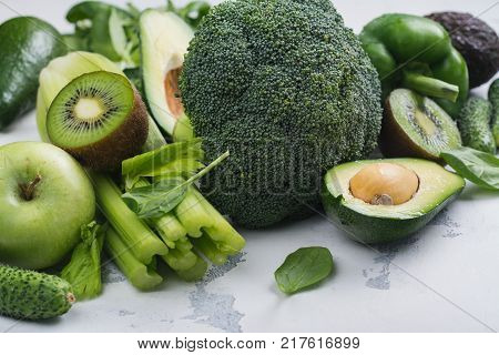 Green fruits and vegetables on white background. Healthy vitamin eating or alkaline diet concept. Copy space