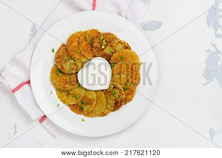 Traditional Hanukkah dish latkes - potato pancakes with sour cream with