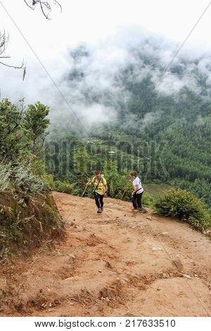 Paro, Bhutan - September 18, 2016: Two Tourist Women Hiking On The Way To Taktshang Palphug Monaster