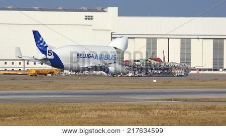 HAMBURG, GERMANY - MARCH 7th, 2014: unloading of aircraft Airbus Beluga in airport Finkenwerder. Every day this plane brings aircraft parts from Toulouse, France, to Airbus plant for further assembly of jets.