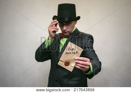 The spy. Secret service. Angry Detecive agent holds pistol gun in his hands aiming and attack. Retro wicked gangster isolated on white background.