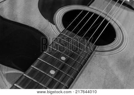 Black and white acoustic guitar with sound hole and pickguard