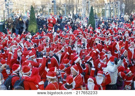 STOCKHOLM SWEDEN - DEC 10 2017: Hundreds of dancing Santas in traditional red dresses and beard in the Stockholm Santa Run in Sweden December 10 2017