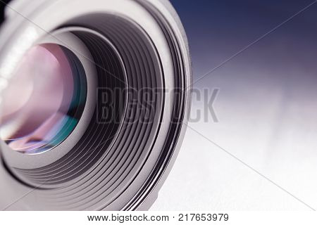camera lens close-up on a white-blue gradient background