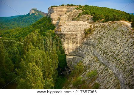 Epic rocks with green forest in a good summer day