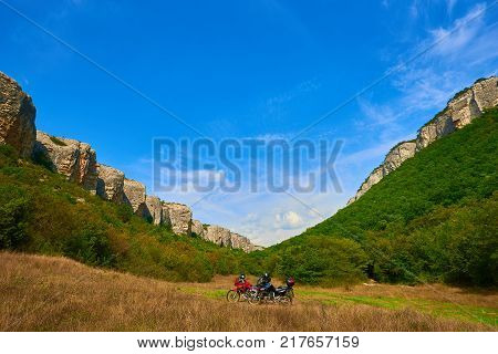 Touristic motorbikes in mountains or rocks under blue sky