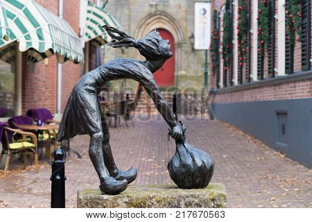 OOTMARSUM NETHERLANDS - DECEMBER 3 2016: Bronze statue of sjalotje (little onion girl) created by Berend Seiger. The onion is the local carnival symbol