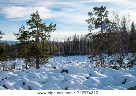Sea of stones covered with snow, beautiful winter landscape. On the way to the mountains