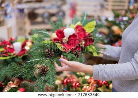 Closeup view of customer choosing Christmas decorations. Various choice of New Year's wreath with decorations