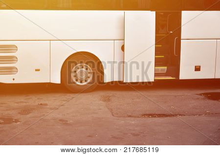 White tourist bus for excursions. The bus is parked in a parking lot near the park