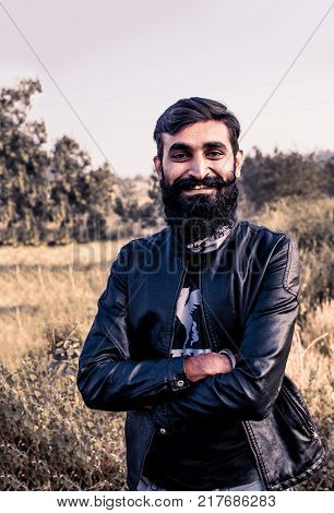 Man with Beard Grown Long and wearing a jacket