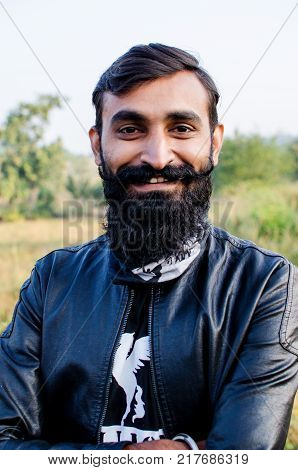 Man with Beard Grown Long and wearing a jacket