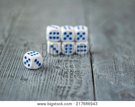 Dice blue and white color on wooden rustic table. Accessories for Board games.
