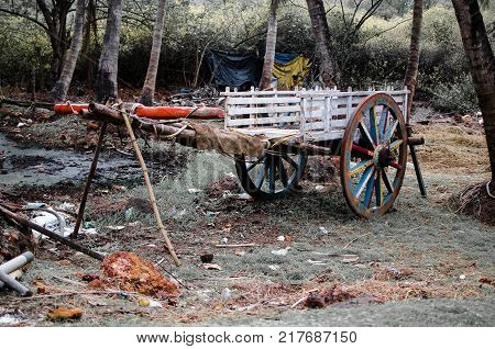 Old wooden Bullock Cart Parked trees and grass in the background