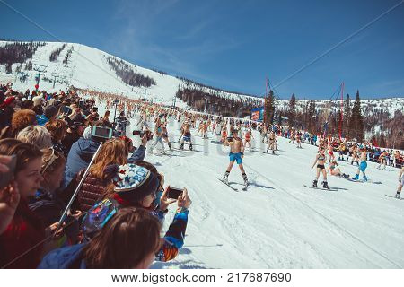 Russia, Sheregesh, - 16.04.2016: Grelka Fest is a sports and entertainment activity for ski and snowboard riders in bikini.girl bikini swimsuit on a snowboard