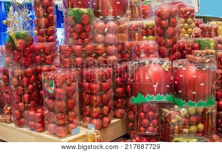 New Year and Christmas shopping. Shelf with red Christmas tree decoration balls. difficult decision. Various choice