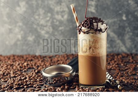 Cold frappe coffee with cream on a gray background