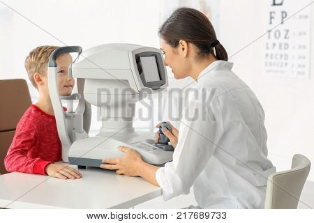 Ophthalmologist measuring intraocular pressure of little child in clinic