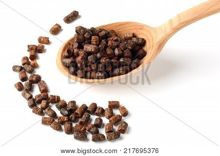 Granules of beer bread in a wooden spoon. Bee pollen Natural remedy for strengthening immunity. Beekeeping product. Apitherapy