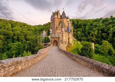 Burg Eltz castle in Rhineland-Palatinate state at sunset, Germany. Construction started	prior to 1157.