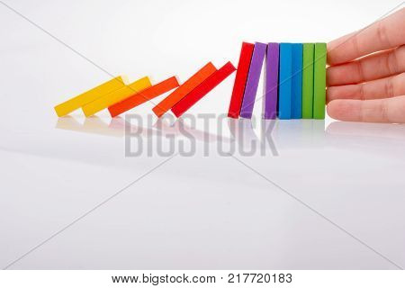 Hand holding color dominoes on a white background