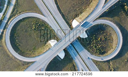 Aerial shot of highway junction with cars top view in the form of a sign of infinity.