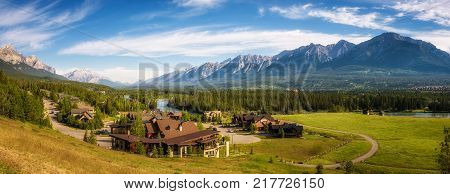 CANMORE, CANADA - JUNE 26, 2017 : Canmore in the Rocky Mountains with mountain peaks in background. Canmore is located in the Bow Valley near Banff National Park and is a popular tourist destination.