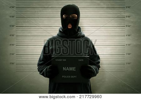Mugshot of criminal masked thief wanted potrait