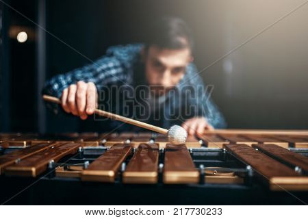 Xylophone player with sticks, musician in action