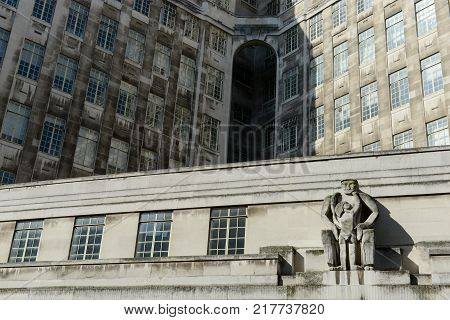 A building facade with a sculpture in London