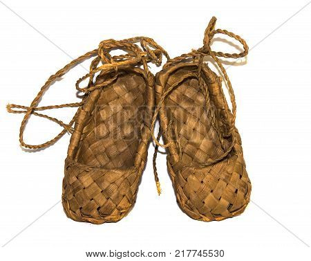 woven birch sandals for everyday wear in the village on a wooden background