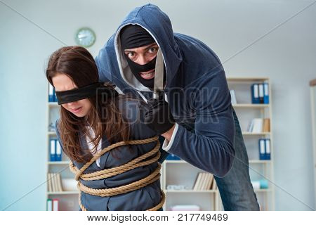 Criminal taking businesswoman as hostage in office