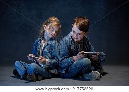 The studio shot of children with mobile phones