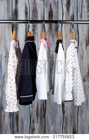 Pajamas on a metal rack in the shop. Hand-crafted sleeping garments for girls and boys. Kids clothing.